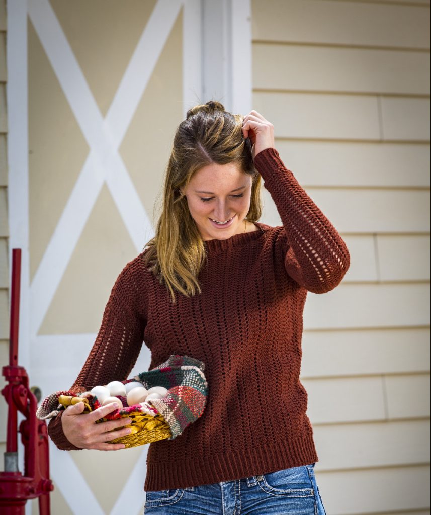 Woman wearing a hand knit all-over lace pullover