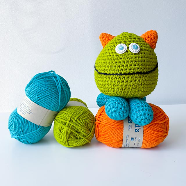 crocheted monster toy made of multicolored bobbles