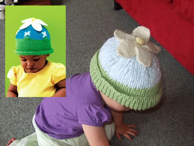 A bird's eye view of a crawling baby wearing a whtie knit hat with a green ribbed brim and topped with a yellow knit flower. Includes inset of another baby wearing a similar hat that also features floral embroidery.
