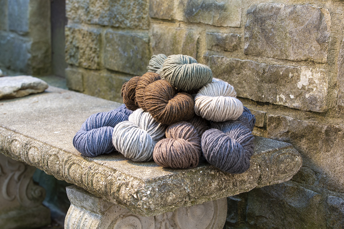Harborside Aran in neutral colors piled on a stone bench