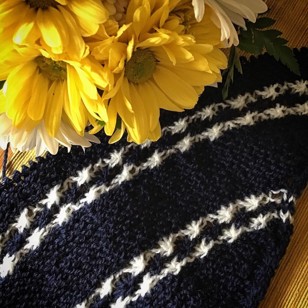First clue in the True Blue shawl in navy and white with yellow flowers