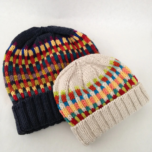 Two knit hats featuring multicolor vertical and horizontal stripes in the middle