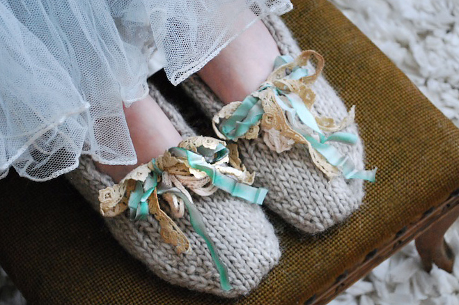 close up of the toes of handknit slippers with ribbon bows