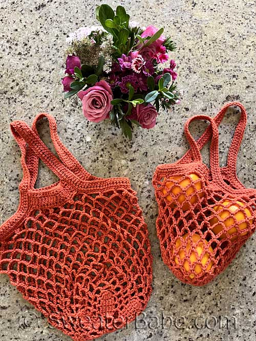 two orange mesh crocheted bags